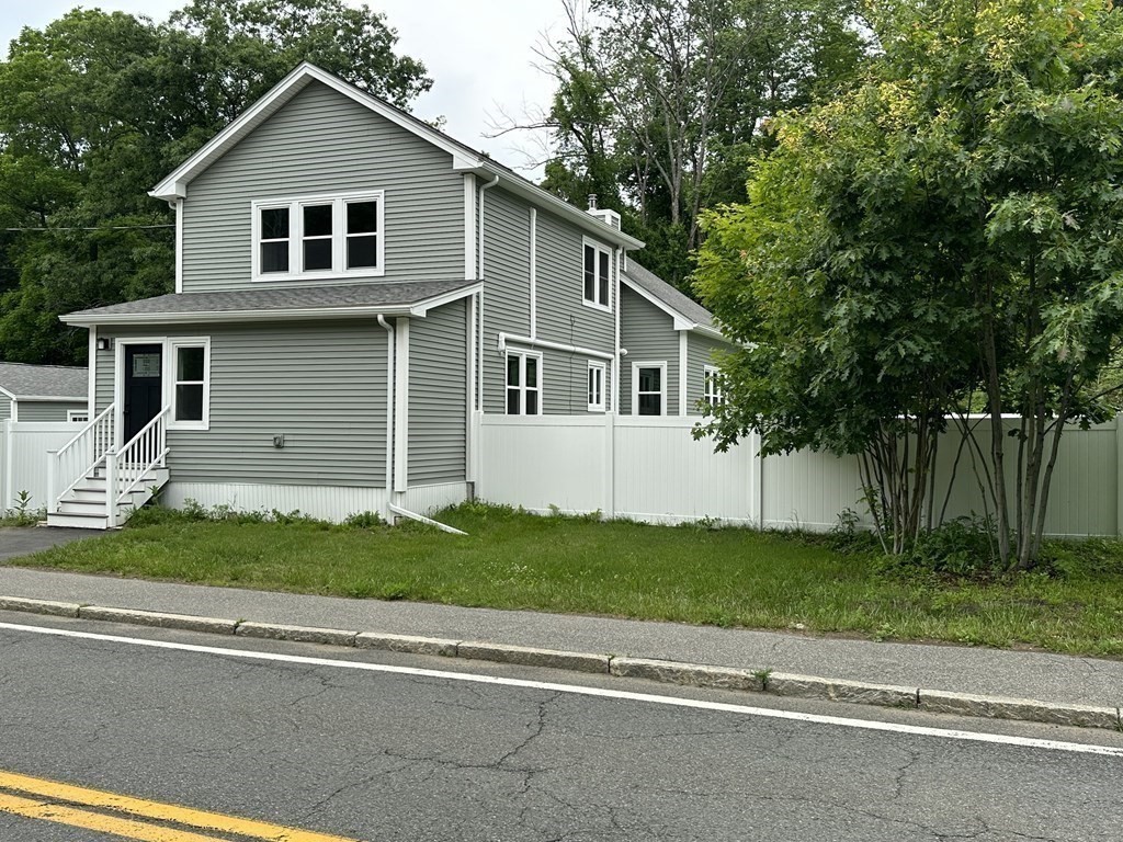 26 Worthington Road Huntington, MA 01050 - Photo 3 of 25 a front view of a house with a garden and garage