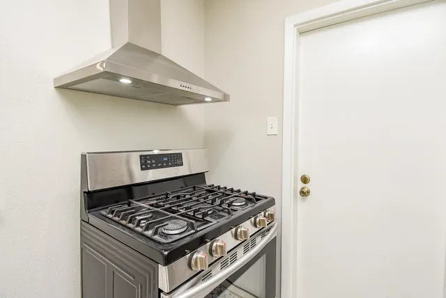 a stove top oven sitting inside of a kitchen