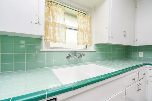 a bathroom with a bathtub and window