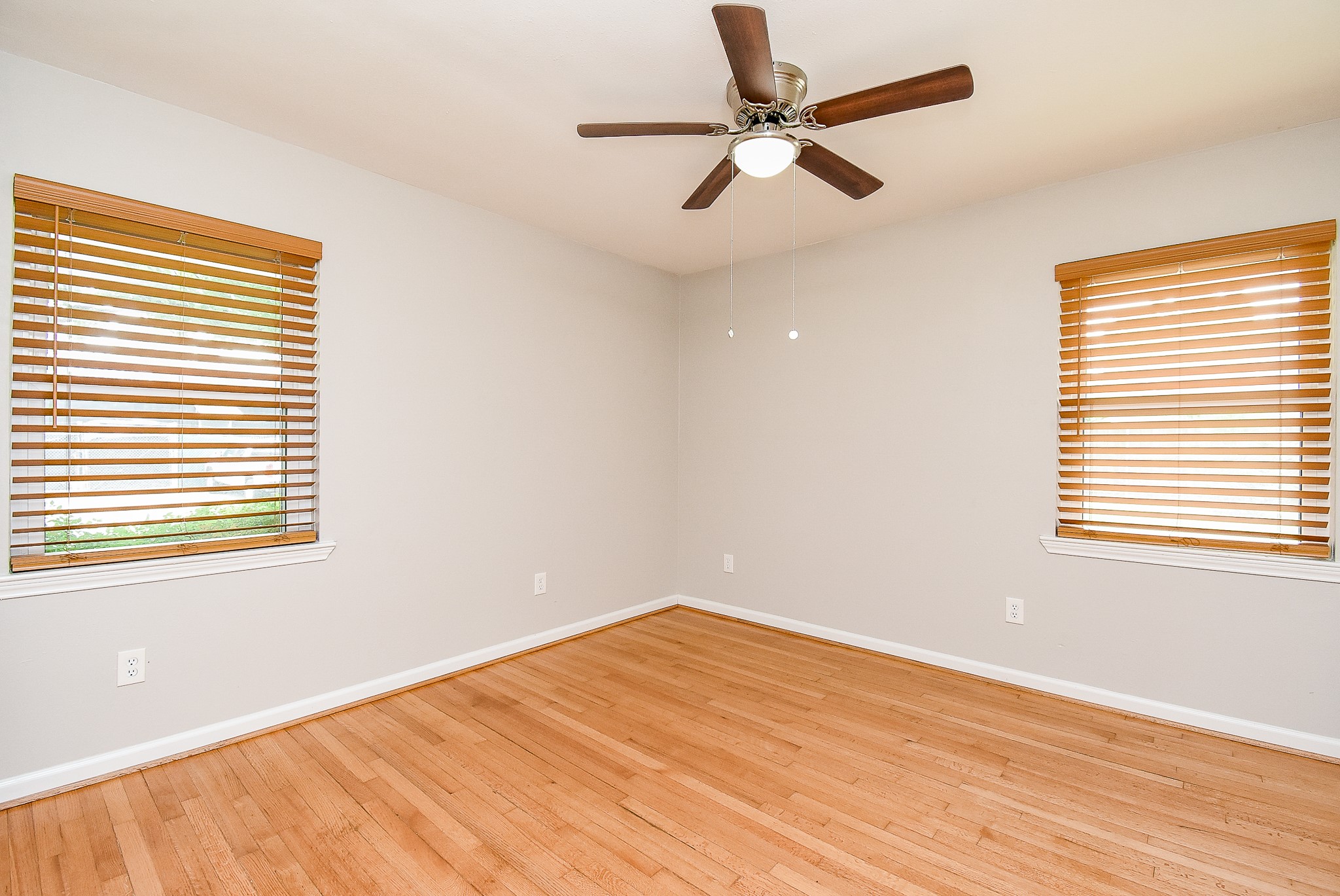 7901 Ridgeview Drive Houston, TX 77055 - Photo 19 of 37 a view of empty room with wooden floor and fan