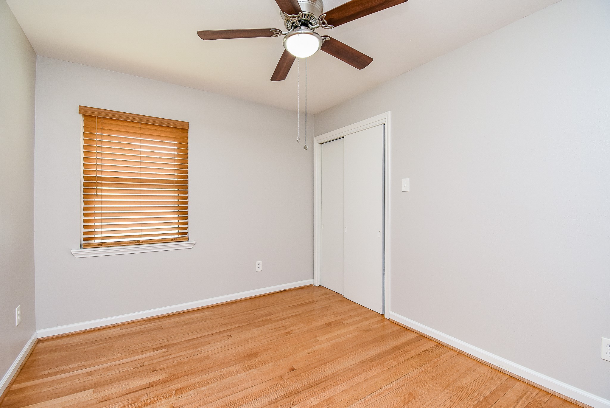 7901 Ridgeview Drive Houston, TX 77055 - Photo 21 of 37 a view of empty room with wooden floor and fan
