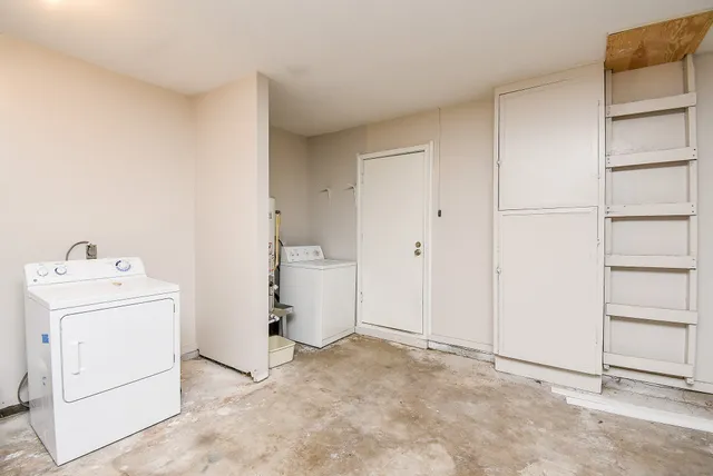a view of storage and utility room with closet