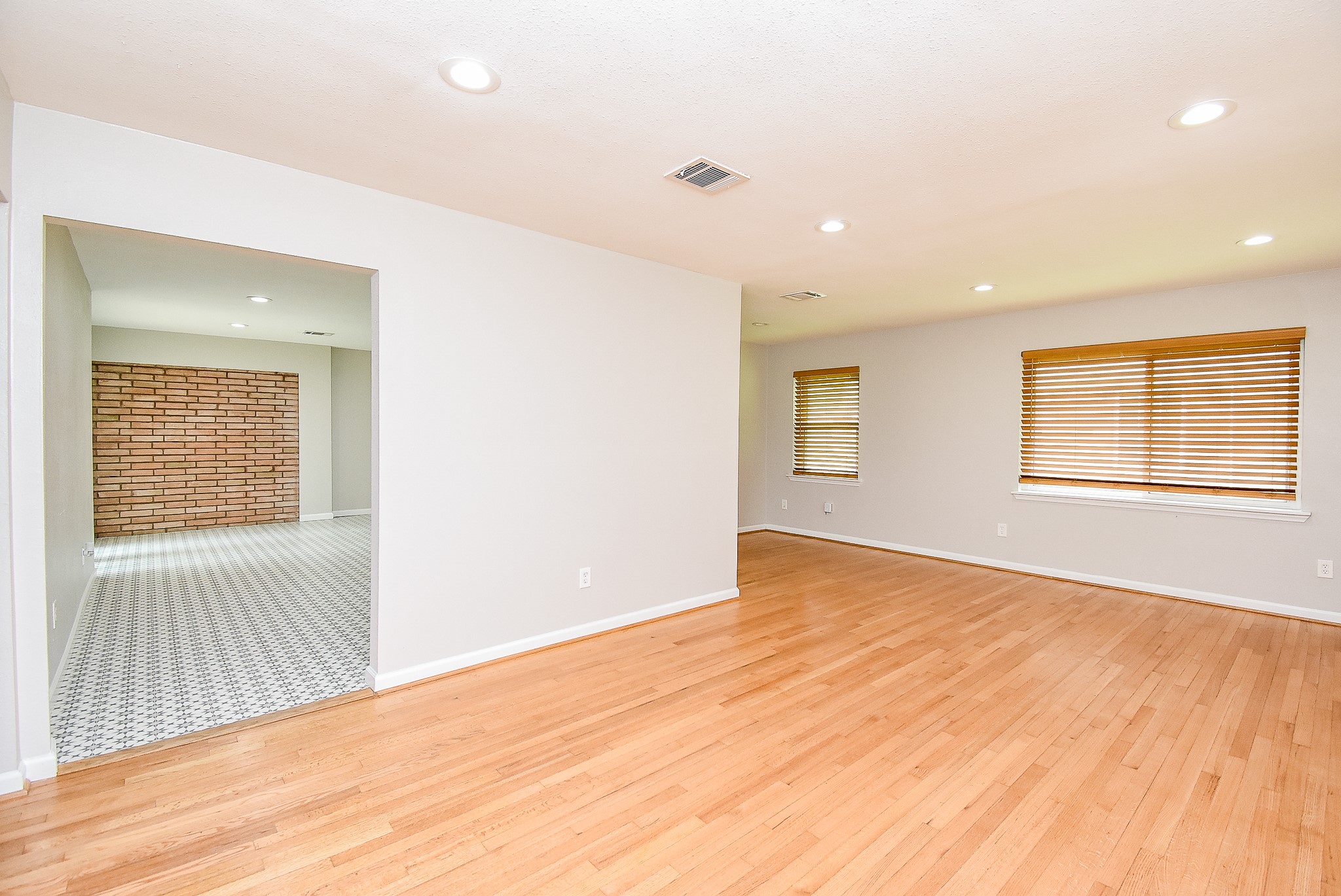 7901 Ridgeview Drive Houston, TX 77055 - Photo 5 of 37 an empty room with wooden floor and windows