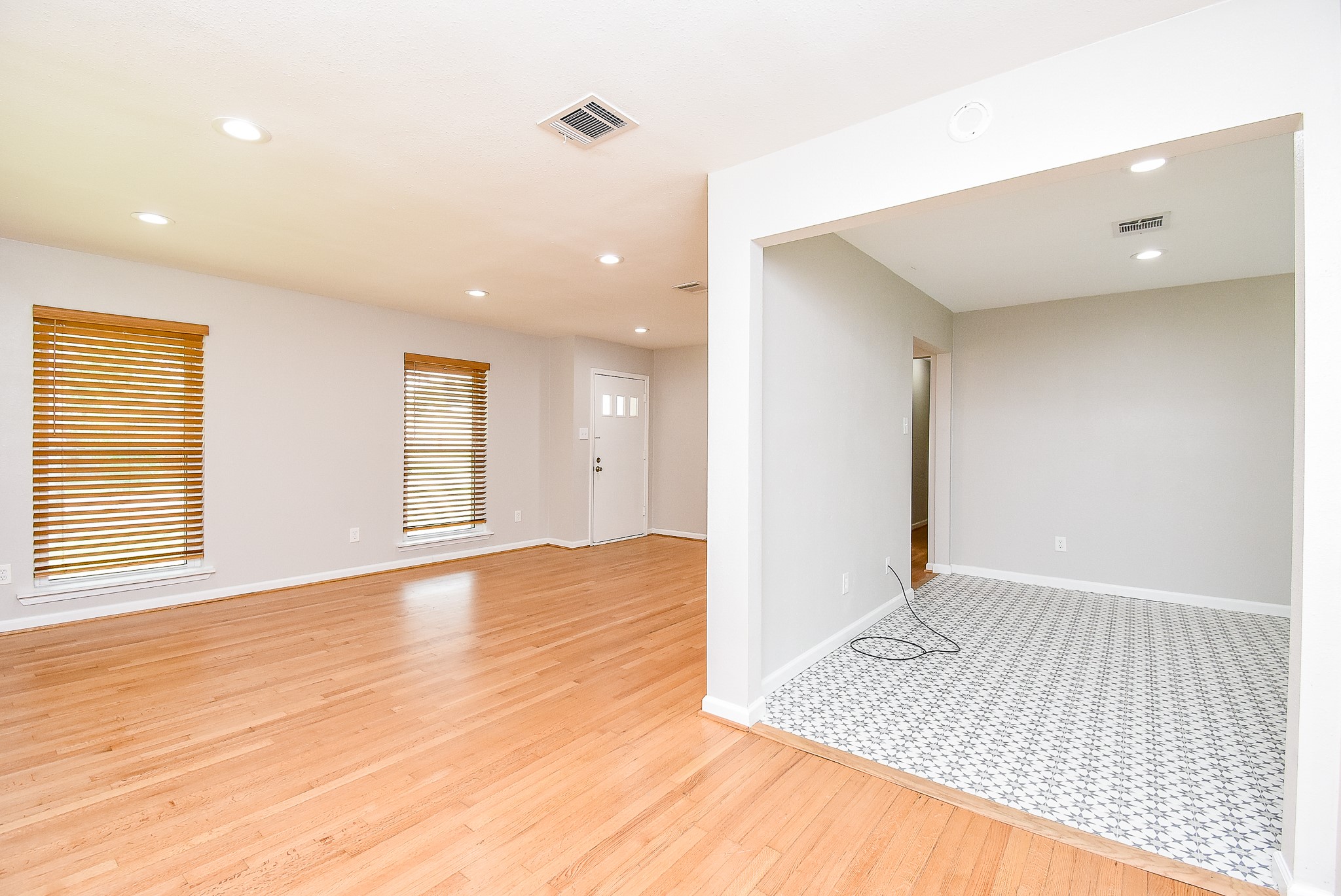 7901 Ridgeview Drive Houston, TX 77055 - Photo 6 of 37 an empty room with wooden floor and windows