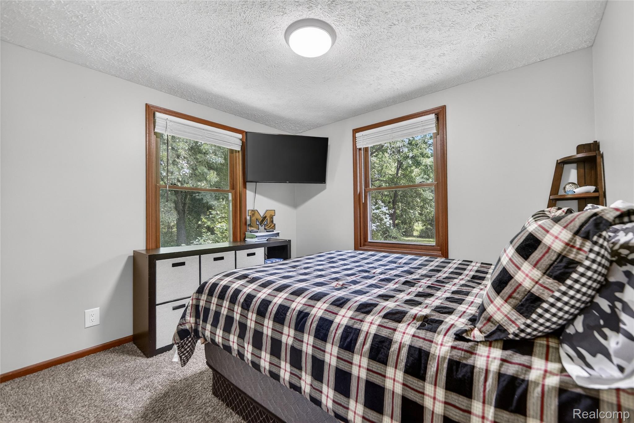 13635 Unadilla Road Gregory, MI 48137 - Photo 20 of 68 Light gray walls and textured ceiling with a central flush-mount light fixture