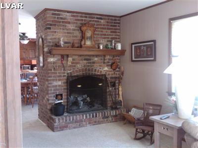 3409 Bridlepath Road Easton, PA 18045 - Photo 5 of 19 Brick wood burning fireplace separates the family