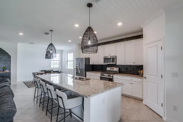 a kitchen with a sink a stove and refrigerator