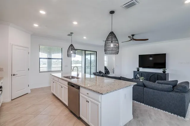 a dining room with furniture a chandelier and wooden floor