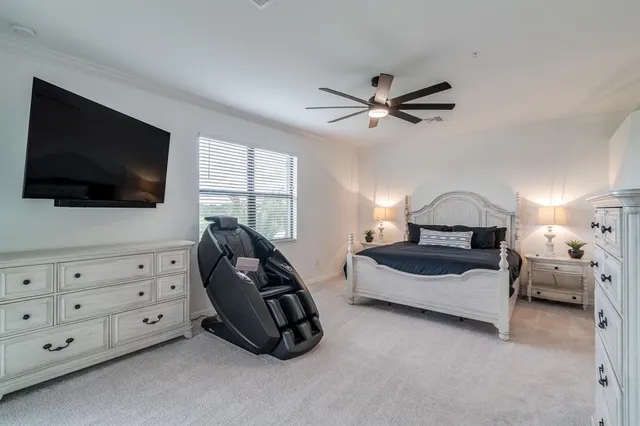 a view of a livingroom with a ceiling fan & a ceiling fan