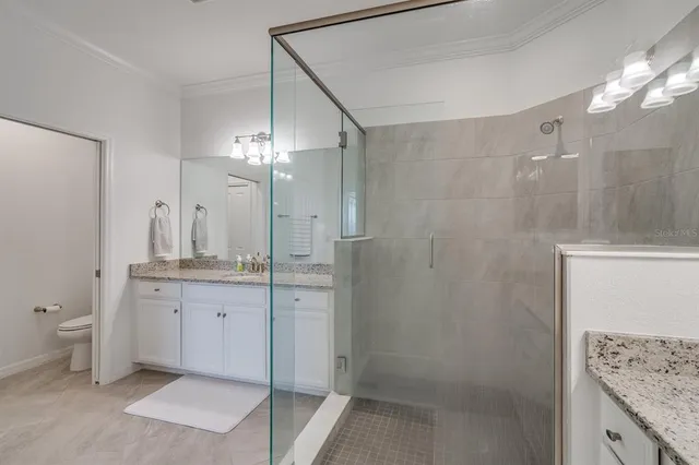 a bathroom with a glass door shower