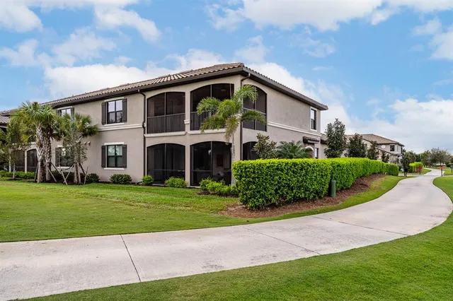 a front view of a house with a garden and plants