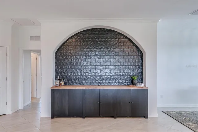 a kitchen with stainless steel appliances granite countertop a refrigerator a stove a sink a dining table and chairs