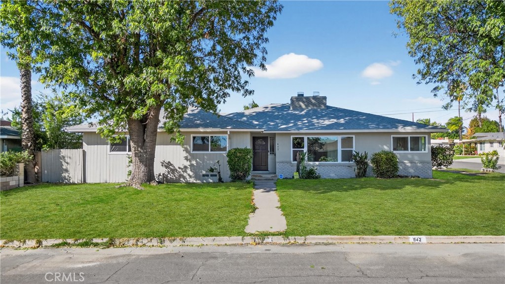 a front view of a house with a garden and yard