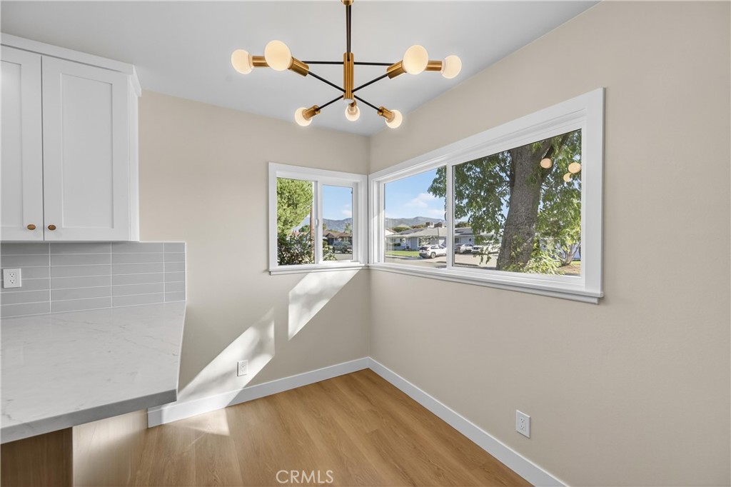 942 North Encina Avenue Rialto, CA 92376 - Photo 11 of 49 a view of an empty room with wooden floor and a window