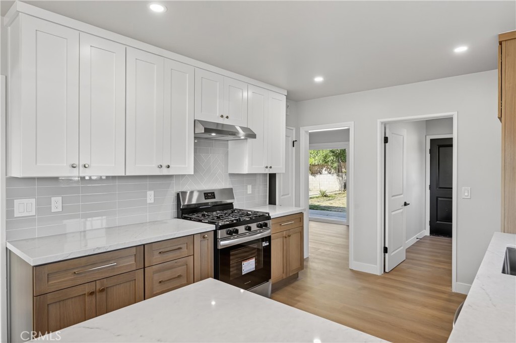 942 North Encina Avenue Rialto, CA 92376 - Photo 15 of 49 a kitchen with granite countertop a sink a stove and cabinets