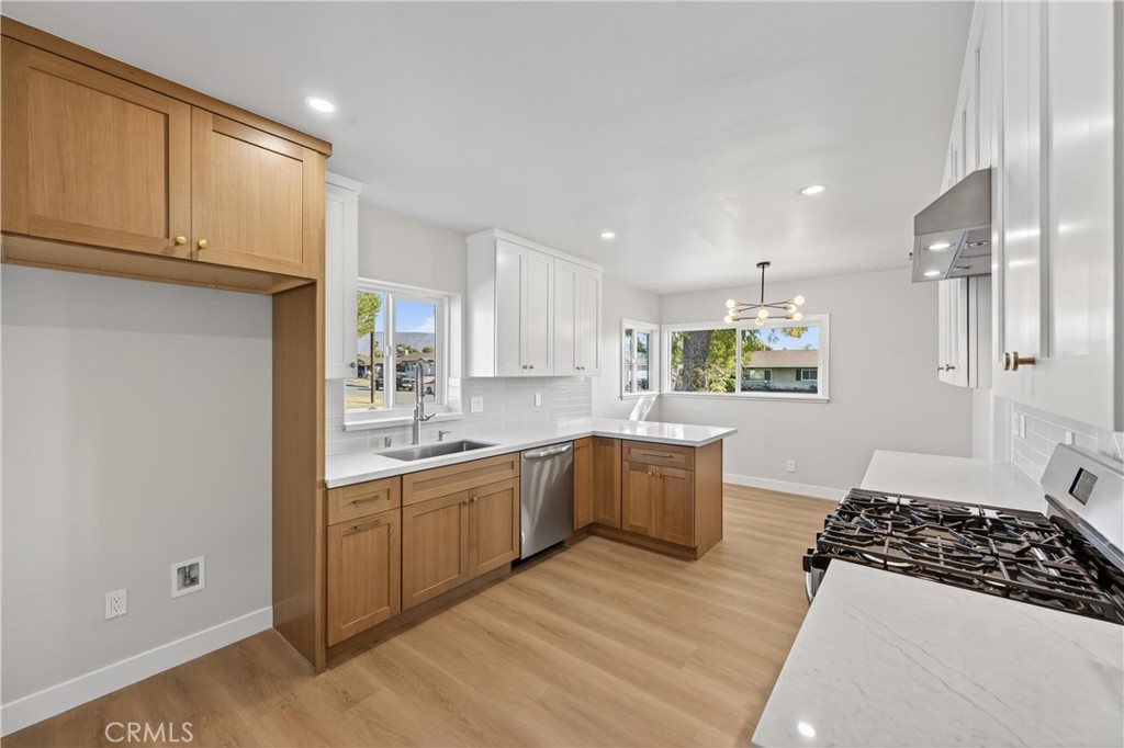 942 North Encina Avenue Rialto, CA 92376 - Photo 21 of 49 a kitchen with a sink stove and cabinets