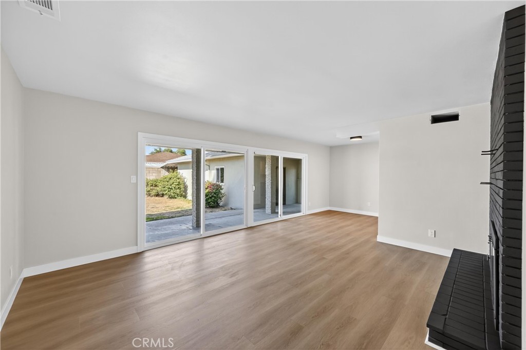 942 North Encina Avenue Rialto, CA 92376 - Photo 25 of 49 a view of an empty room with wooden floor and a window
