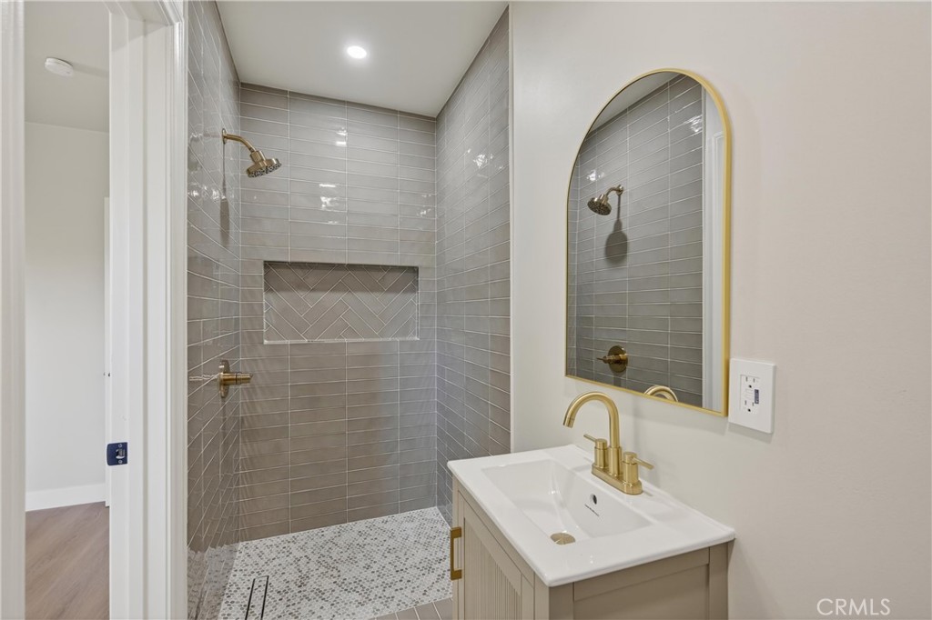 942 North Encina Avenue Rialto, CA 92376 - Photo 28 of 49 a bathroom with a sink a shower and a mirror