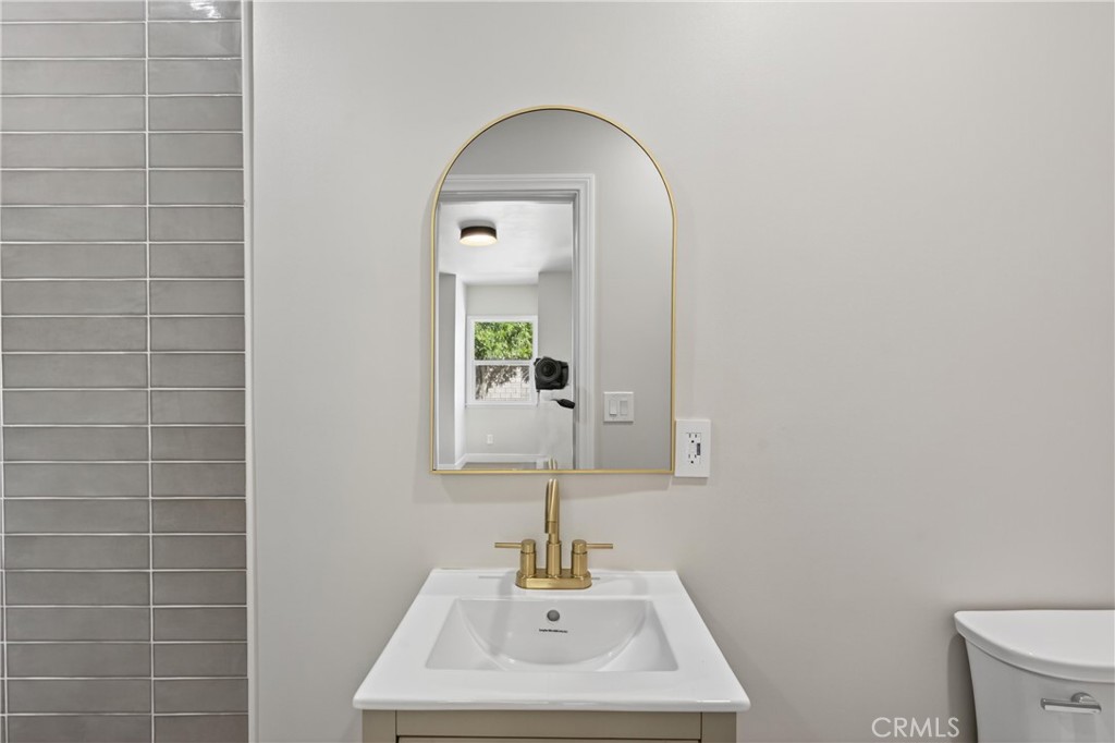 942 North Encina Avenue Rialto, CA 92376 - Photo 29 of 49 a bathroom with a sink a toilet and mirror