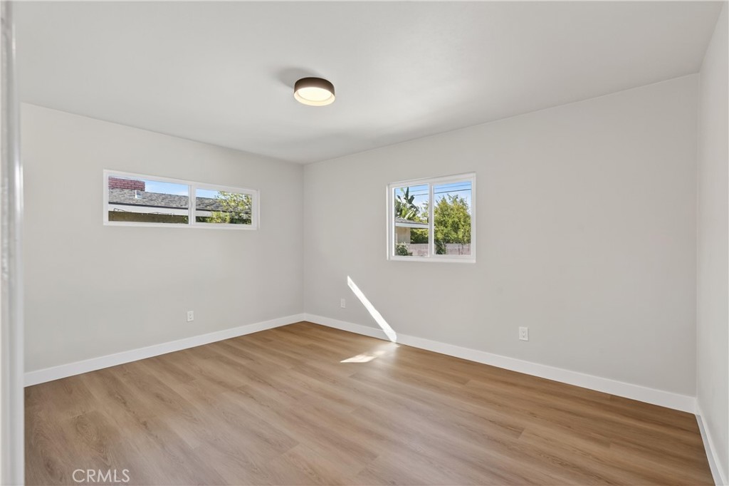 942 North Encina Avenue Rialto, CA 92376 - Photo 30 of 49 an empty room with wooden floor and windows
