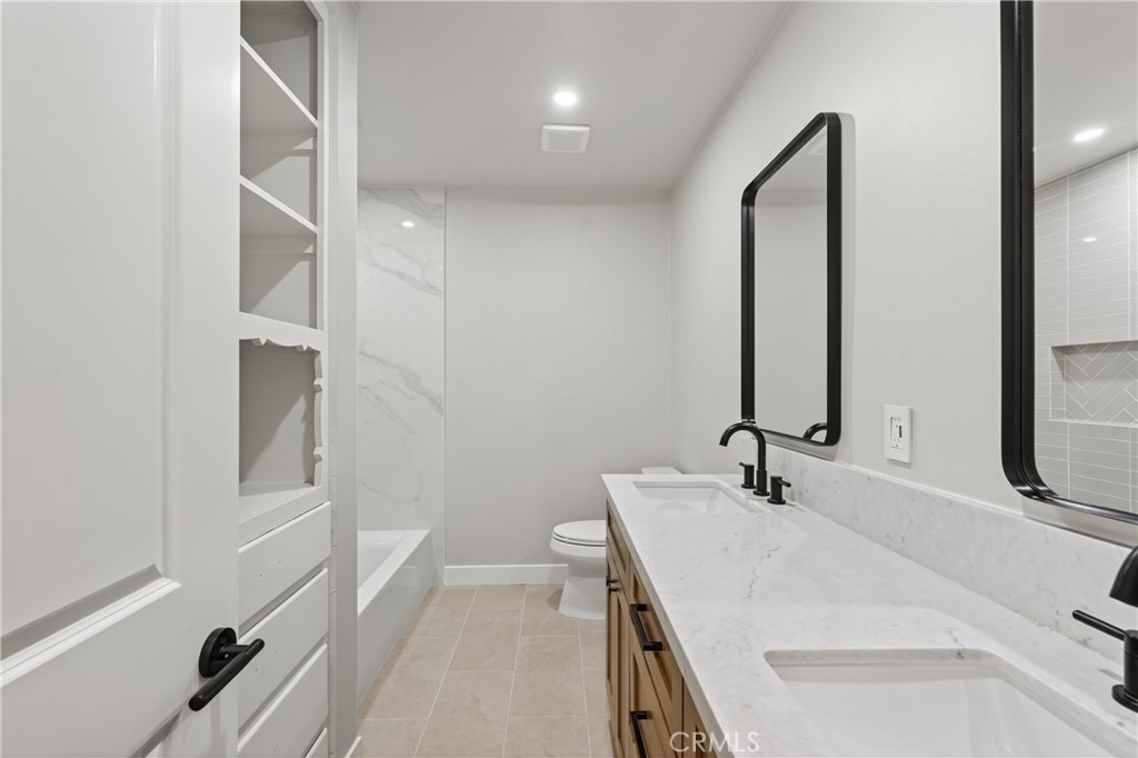 942 North Encina Avenue Rialto, CA 92376 - Photo 38 of 49 a bathroom with a sink and a mirror