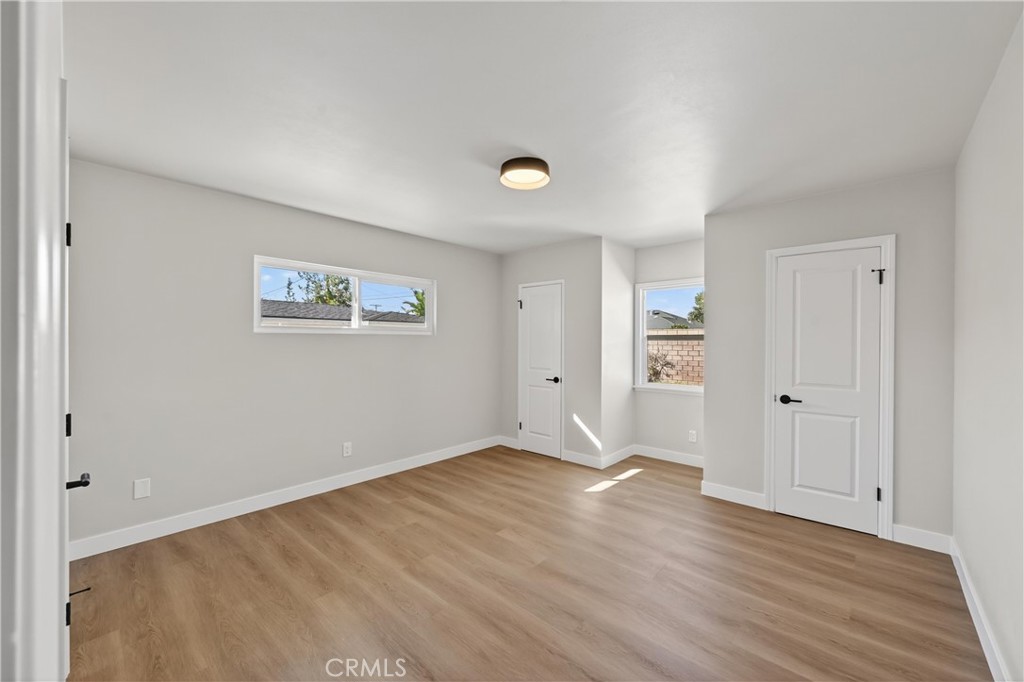 942 North Encina Avenue Rialto, CA 92376 - Photo 40 of 49 a view of an empty room with wooden floor and a window