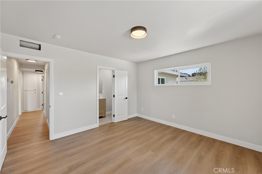 942 North Encina Avenue Rialto, CA 92376 - Photo 41 of 49 an empty room with wooden floor and windows