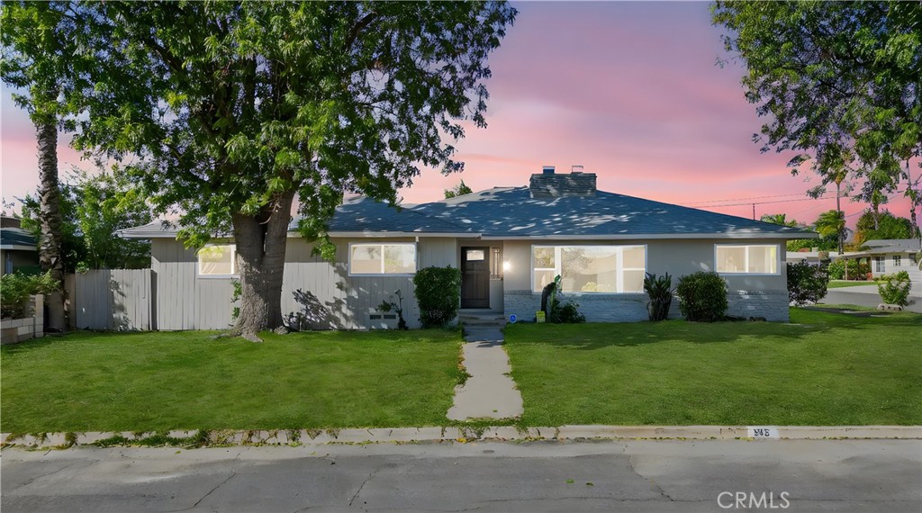 942 North Encina Avenue Rialto, CA 92376 - Photo 49 of 49 a front view of a house with a garden and yard