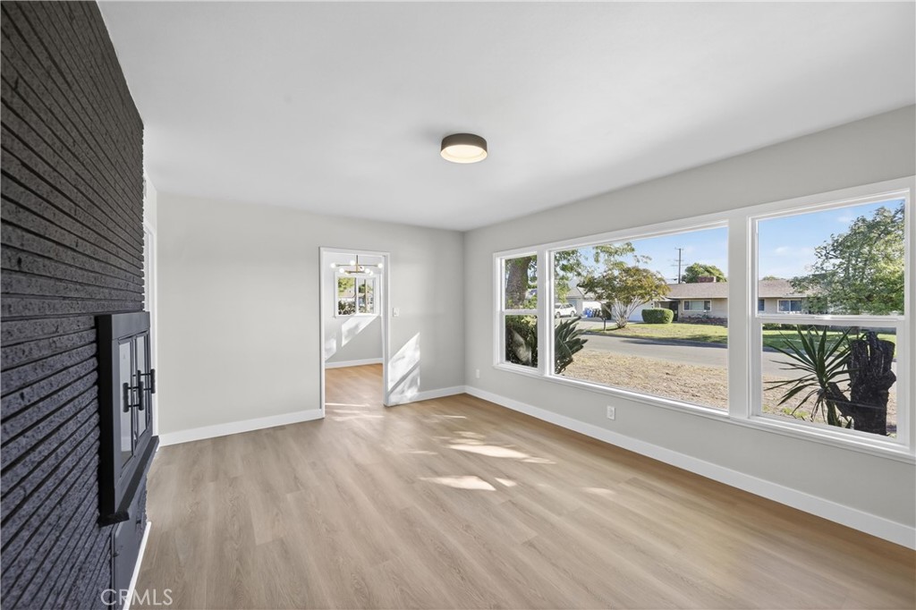 942 North Encina Avenue Rialto, CA 92376 - Photo 7 of 49 a view of an empty room with a window and wooden floor