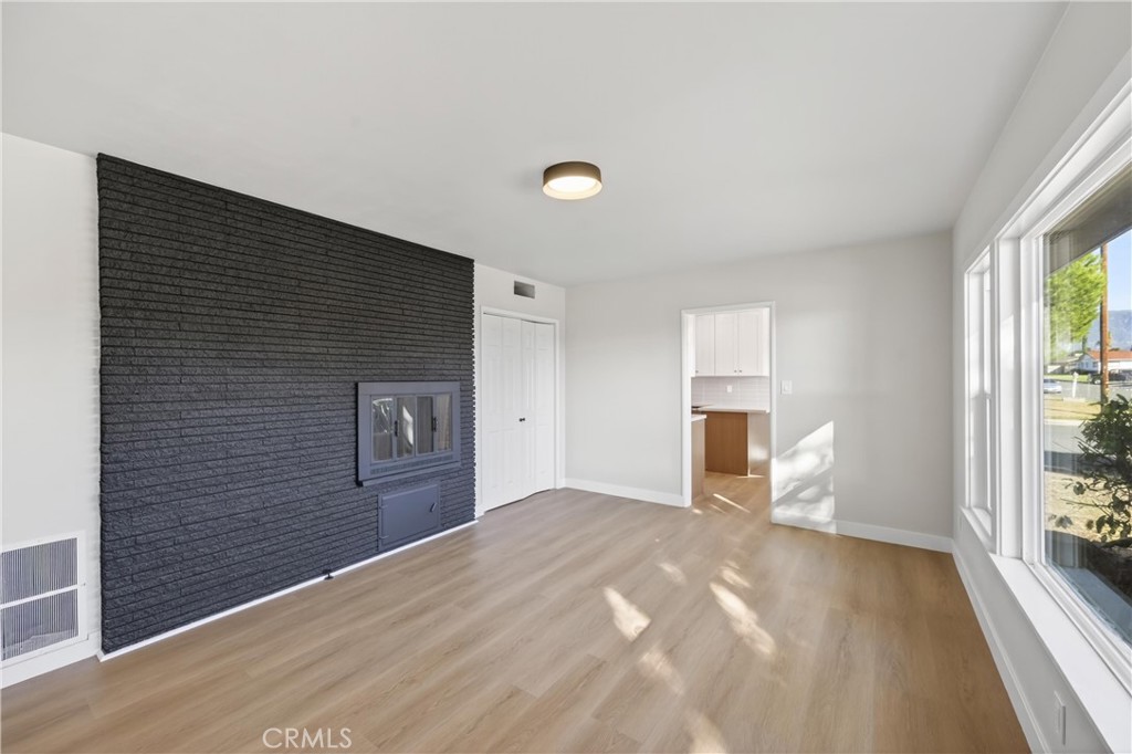 942 North Encina Avenue Rialto, CA 92376 - Photo 8 of 49 a view of empty room with a fireplace and windows