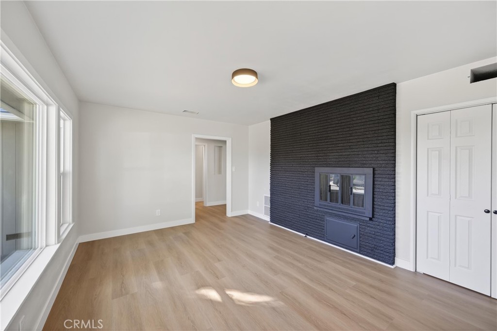 942 North Encina Avenue Rialto, CA 92376 - Photo 9 of 49 a view of empty room with wooden floor and fan