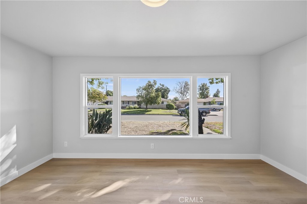 942 North Encina Avenue Rialto, CA 92376 - Photo 10 of 49 a view of a livingroom with wooden floor and a window