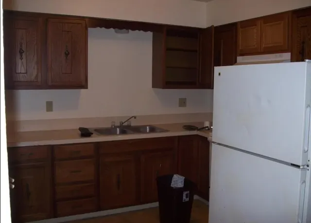 a kitchen with a refrigerator and a sink