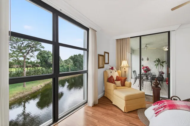 a living room with furniture and a floor to ceiling window