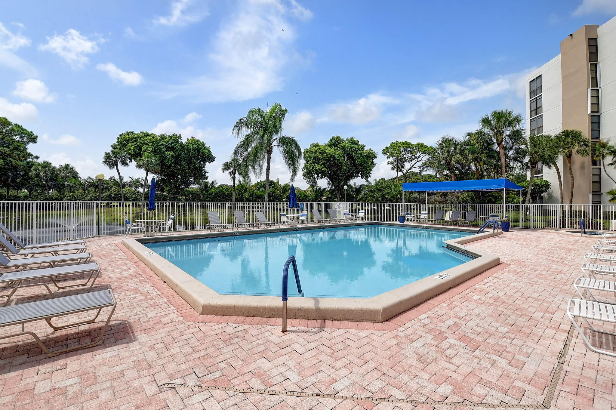 6562 Boca Del Mar Drive, Unit 326 Boca Raton, FL 33433 - Photo 22 of 25 a view of a swimming pool with a lounge chairs