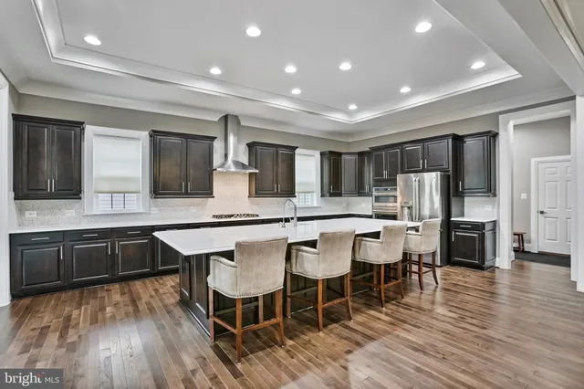 a large kitchen with a table and chairs