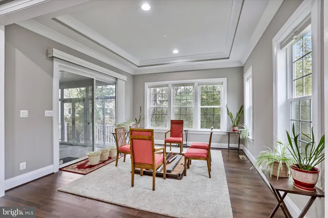 a dining room with furniture wooden floor and a potted plant
