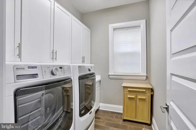 a kitchen with stainless steel appliances white cabinets and a refrigerator