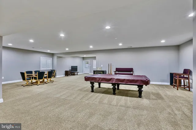 a living room with furniture a flat screen tv and a table