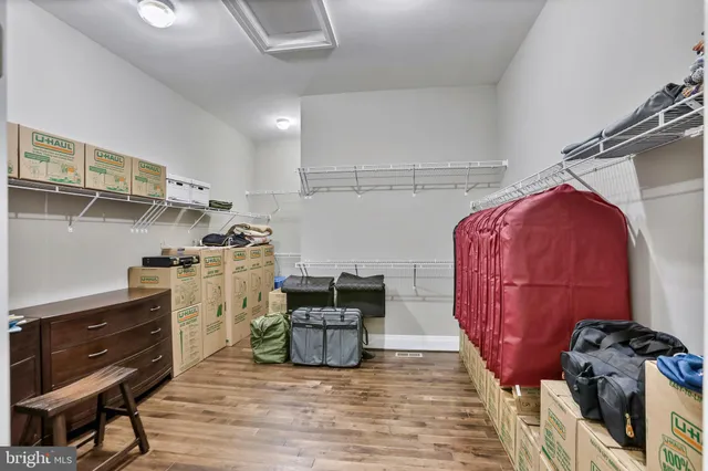 a hallway with a door and a closet