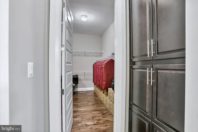 a storage and utility room with two washing machine
