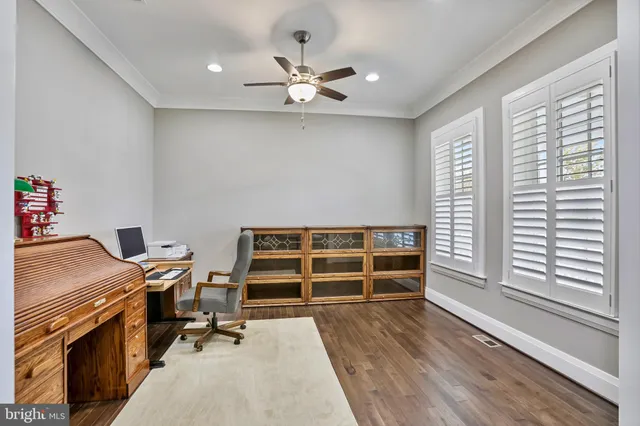 a view of workspace with wooden floor and windows