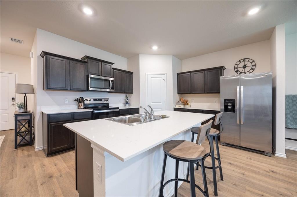 729 Amelia Court Pilot Point, TX 76258 - Photo 10 of 40 Kitchen with island and breakfast bar