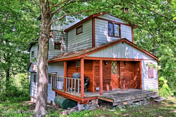 a view of wooden house with large windows
