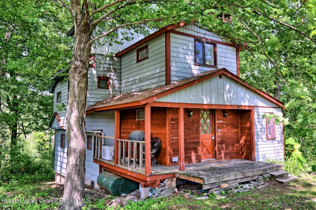 a view of wooden house with large windows