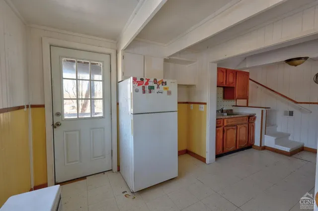 an aerial view of residential houses with outdoor space and trees