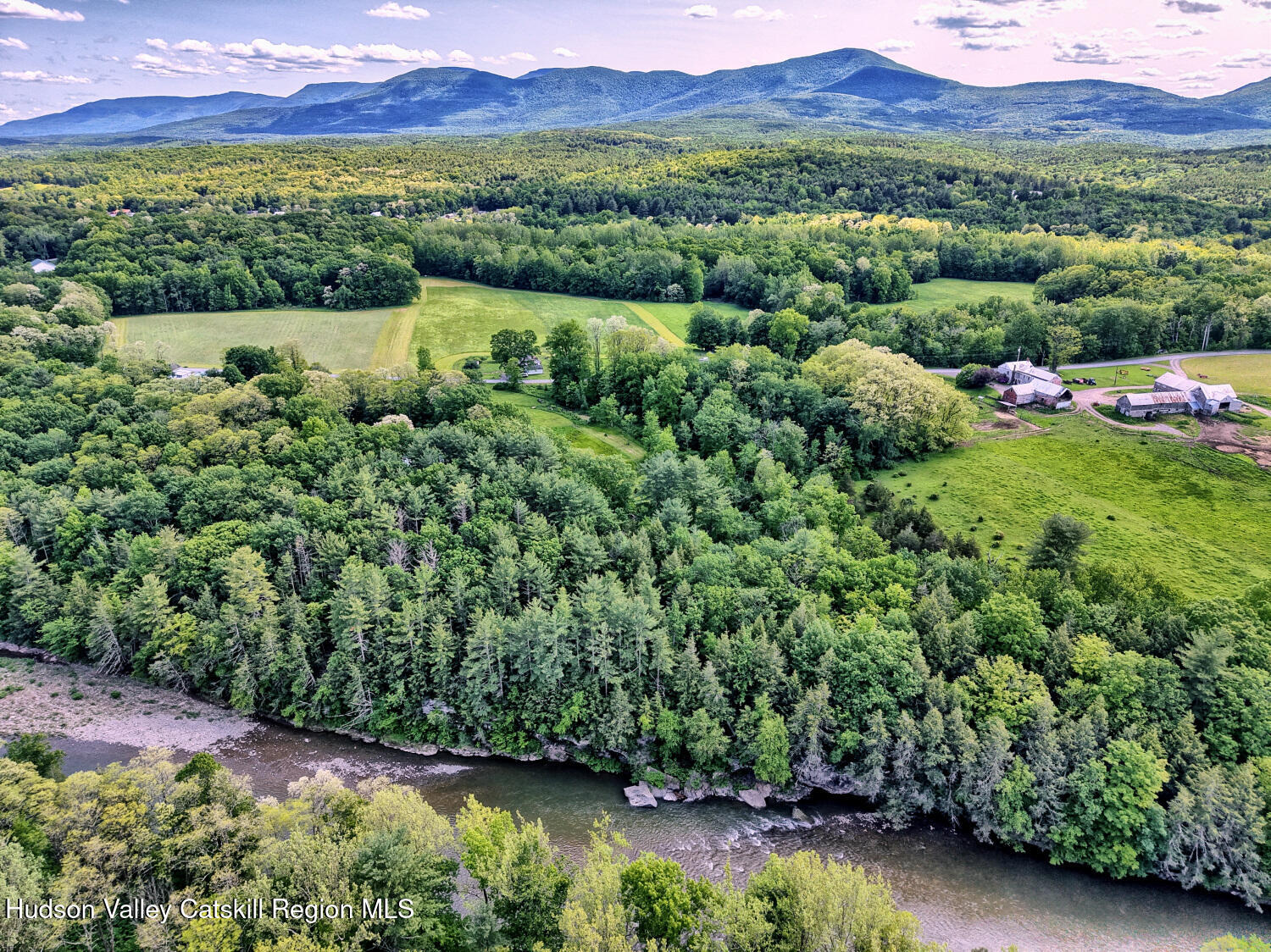 360 Stone Bridge Rd Extension East Durham, NY 12423 - Photo 77 of 83 a view of a lush green field with mountains in the background