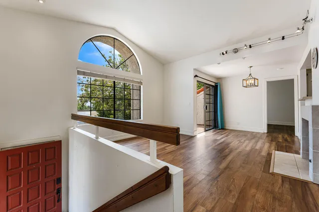 a view of an entryway with wooden floor