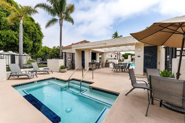 a view of a patio with swimming pool table and chairs