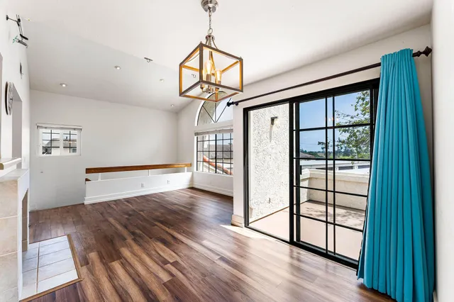 a view of a room with wooden floor and windows